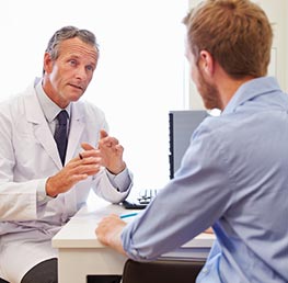 photo of a doctor talking to a male patient
