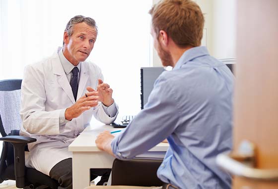 photo of a doctor talking to a male patient
